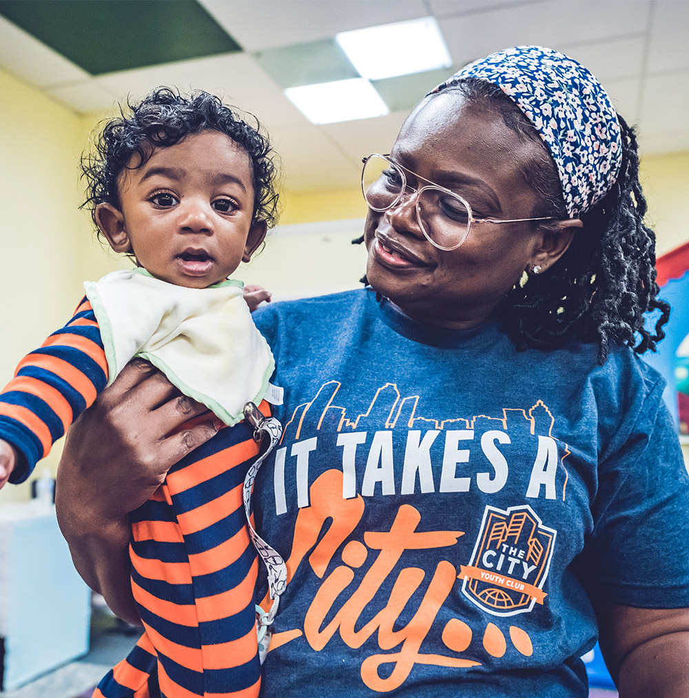 Mom holding a baby at City of Refuge