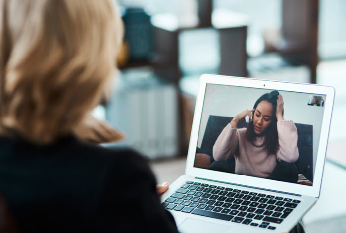 woman participates in telehealth session with behavioral health provider