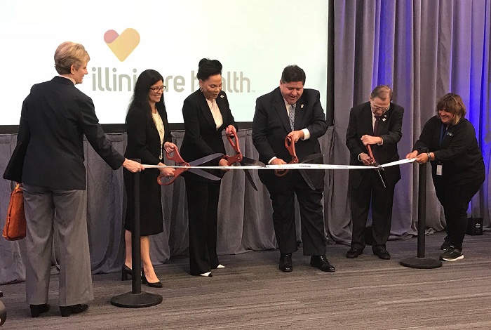 Centene CEO Michael Neidorff and Illinois Governor cut ceremonial ribbon with other executives