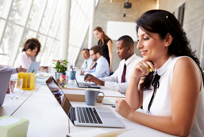 a diverse group of employees work in office