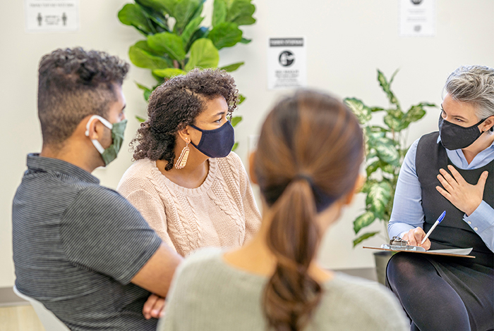 People in a meeting wearing masks