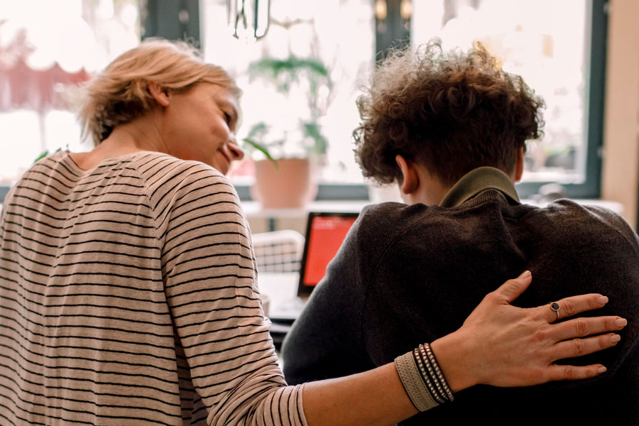 A woman comforting someone in need