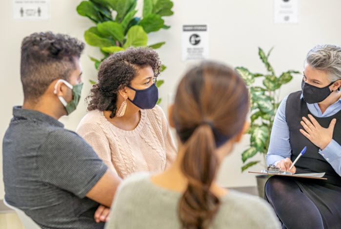 individuals participate in group therapy session