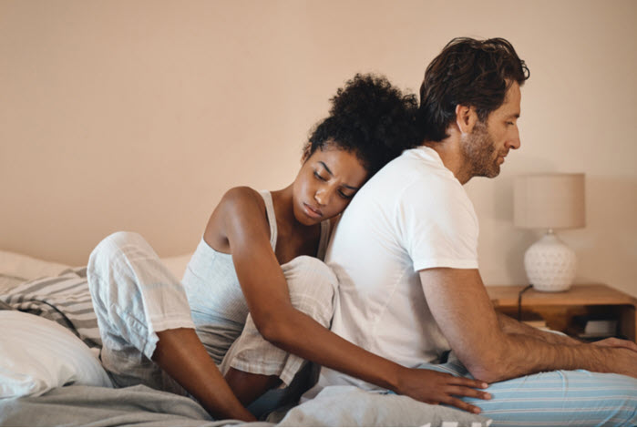 woman comforts man turned away from camera