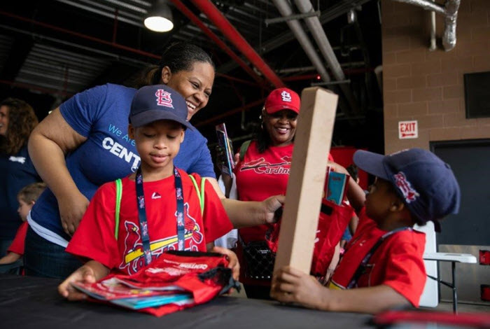 Centene employee hands out school supplies to children