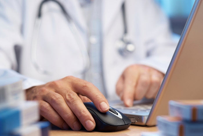 doctor's hand clicking mouse