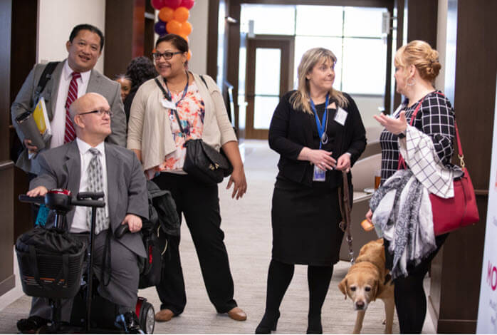 diverse group of employees gather in hallway