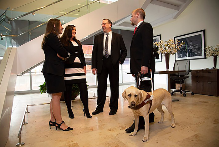 group of employees and service dog