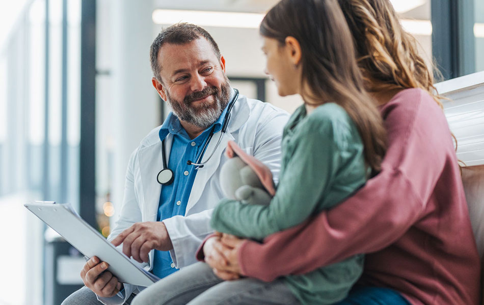 Doctor at a community health center providing care to a child and parent 