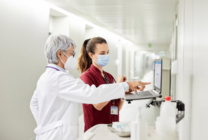 doctors view information on laptop