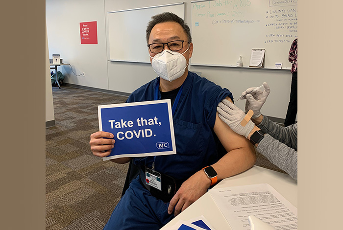 doctor receives COVID-19 vaccination