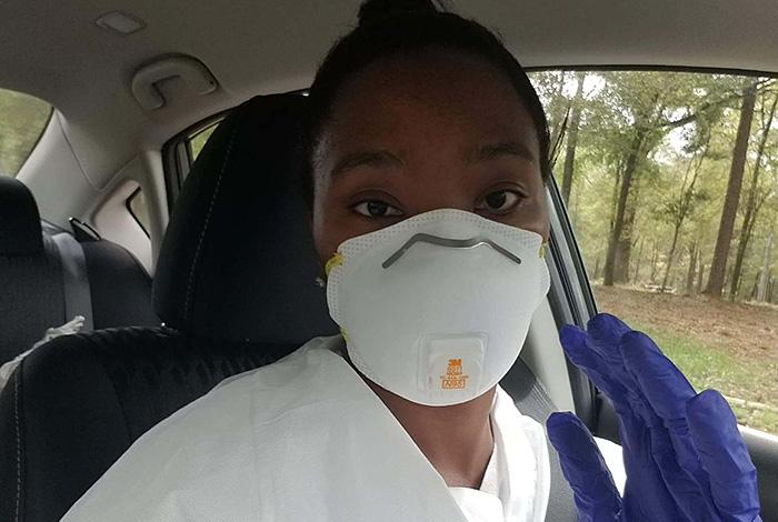 woman wearing mask sitting in car
