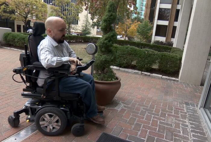 man in wheelchair enters doctor's office