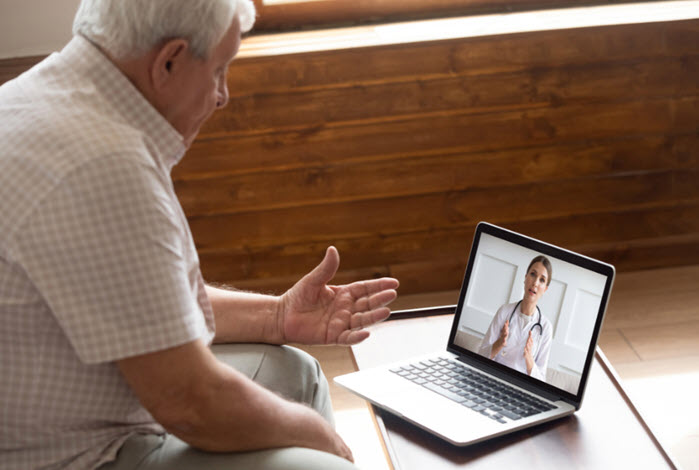 man consults with provider at home