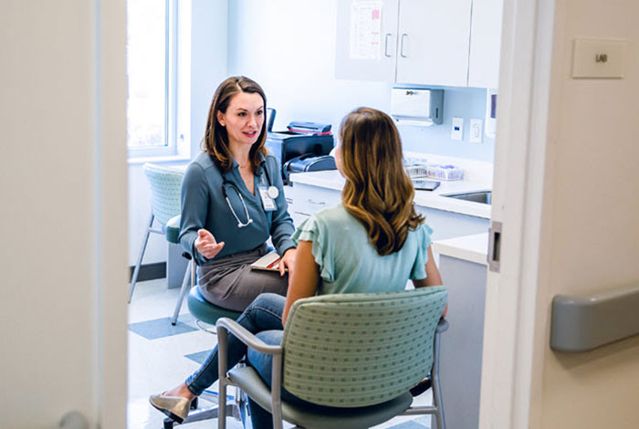 physician talking to a patient in office