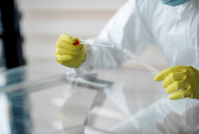 healthcare worker holds swab test