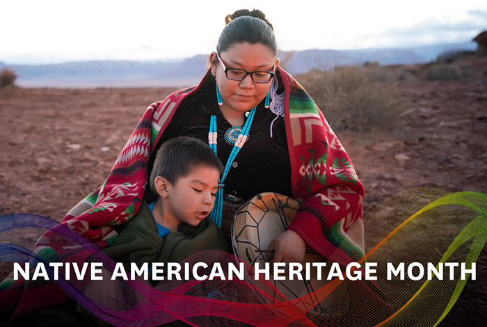 mother and son of Native American descent playing instruments outdoors