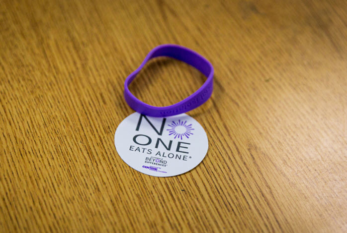 No One Eats Alone rubber bracelet and sticker