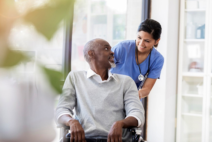 Nurse talking to a patient in wheelchair