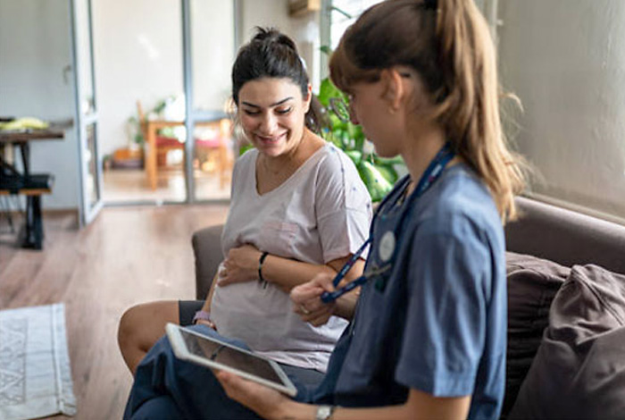 Nurse with pregnant patient.