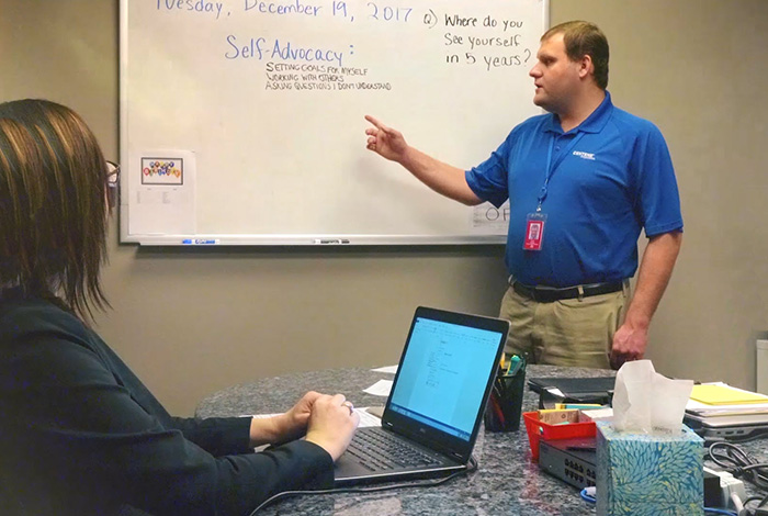 project search employee presents in front of a whiteboard