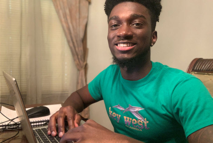 intern sits at laptop computer