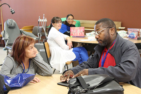 Two people having a conversation at a medical facility 