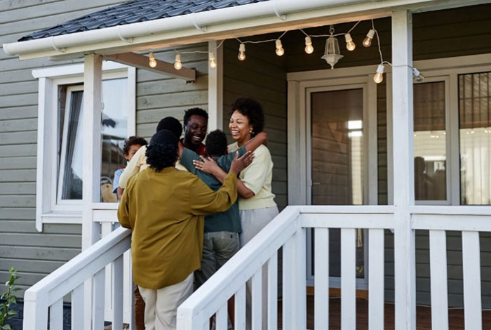 Family on front porch of their house