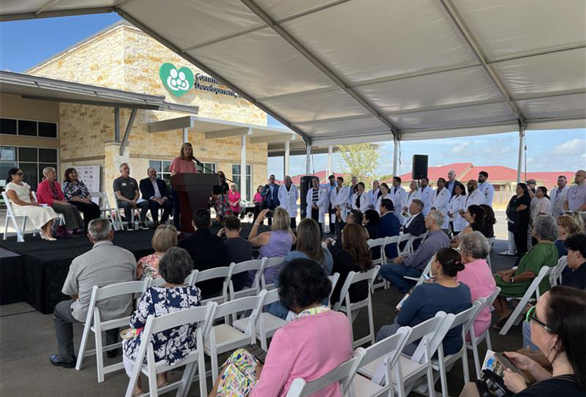 A party with the speaker and the attendees under a tent
