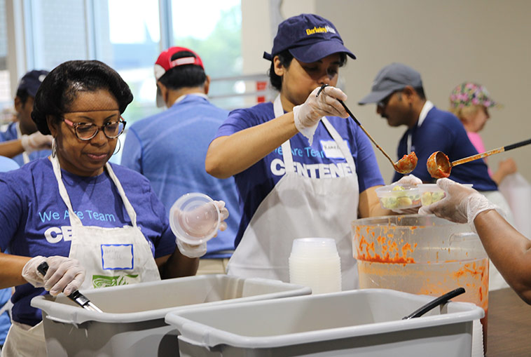 Volunteers at food bank serving food