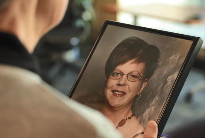 woman holding framed photo