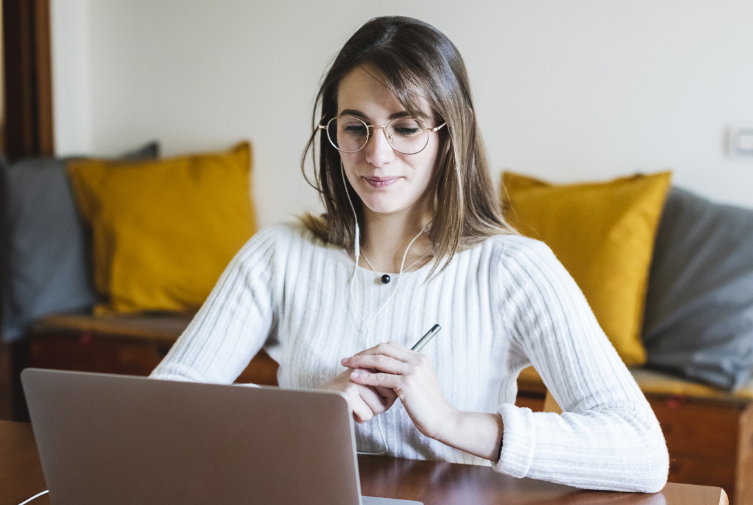 Student woman during e-learning on laptop at home