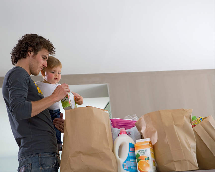 Person with baby unloading groceries